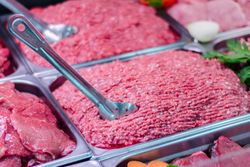 Close-up of fresh meat and minced beef in a retail display at San Vito market, Costa Rica.